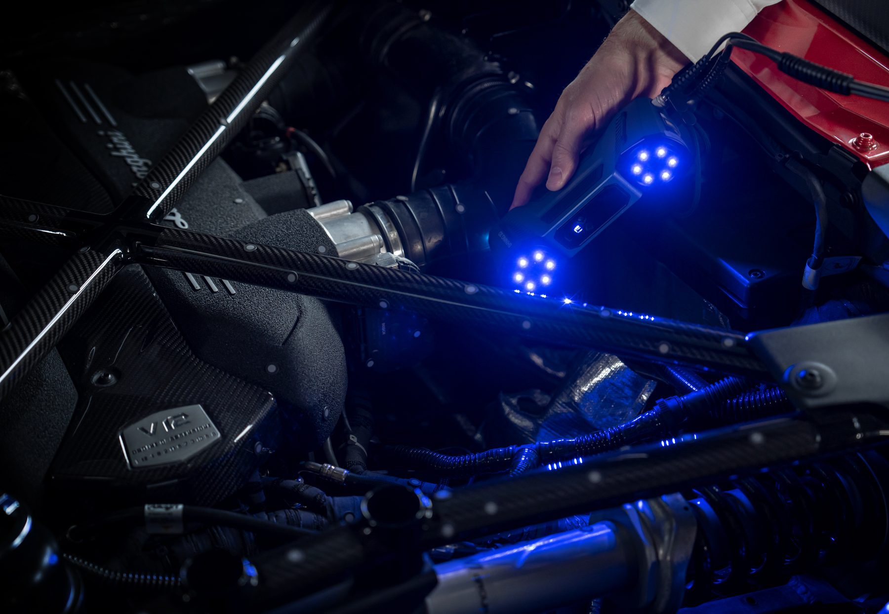 FreeScan Combo Series scanning inside tight engine bay — narrow-space and deep-hole access with single-line mode on high-performance automotive powerplant