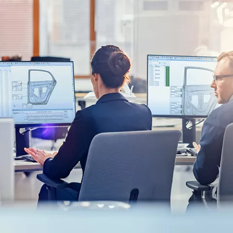 PolyWorks Inspector — engineers reviewing inspection results on dual monitors